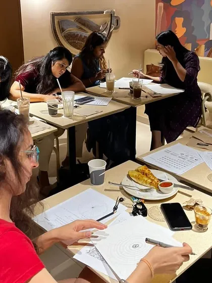 Participants deeply engaged in their artwork during a World Art Day session. I provide all the tools and guidance so everyone can find their flow.