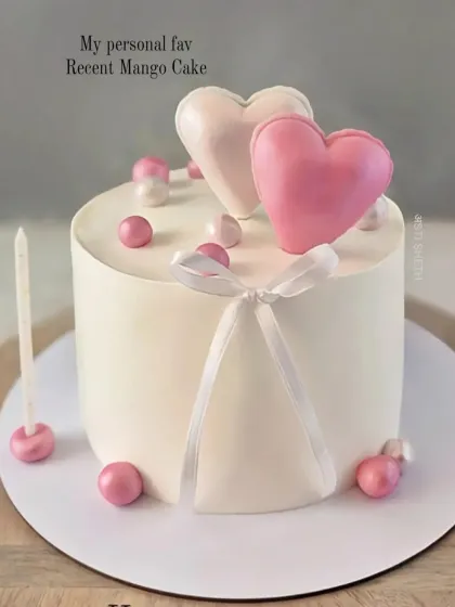 A personal favourite of mine, this minimalist mango cake is decorated with two simple balloon hearts and pearl details.