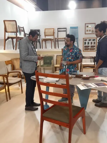 Deep in conversation with a designer about a specific chair model. I can customize any of my designs to fit a project's requirements.