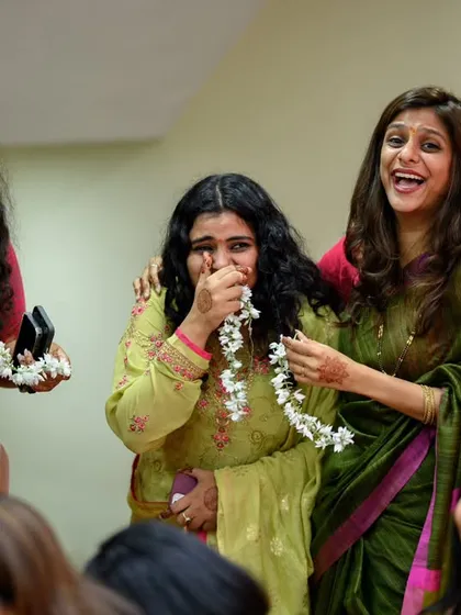 A mix of laughter and happy tears among friends. One friend gets emotional while others laugh, a beautiful and real moment that shows the deep bonds of friendship.