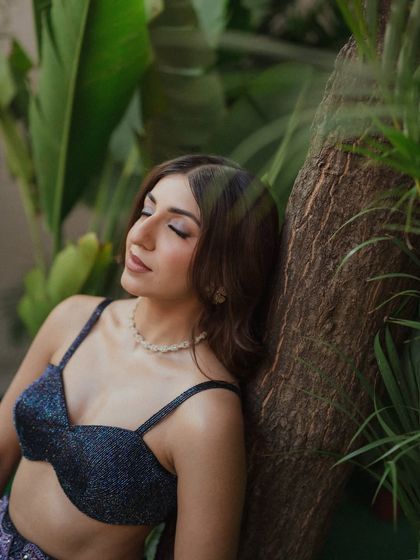 A serene moment for Sheena. With her eyes closed, you can appreciate the soft, blended eyeshadow and the gentle contouring that defines her features.