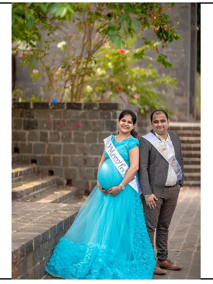 A proud portrait of the expecting parents wearing their celebratory sashes.