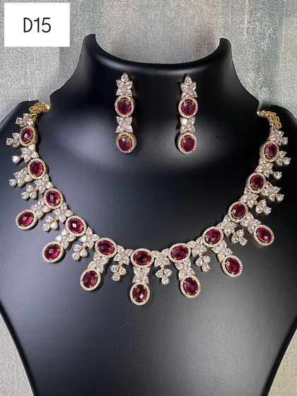 A simple yet elegant necklace in a gold finish with ruby-colored stones. This is a great rental option for adding a touch of traditional color to your look without being too heavy.