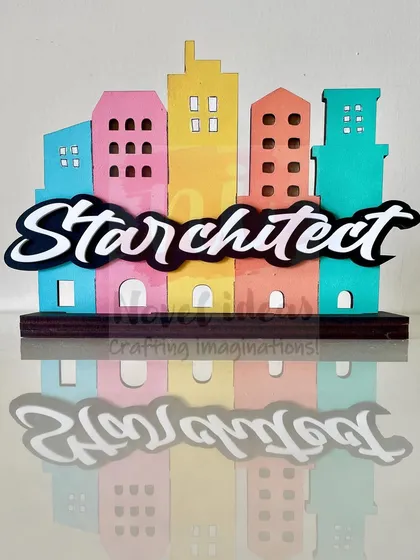 A straight-on view of the 'Starchitect' standee, showing its colorful building silhouettes and bold lettering.