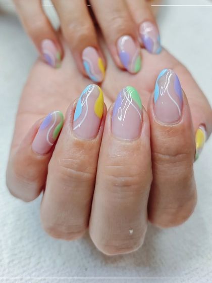 Abstract nail art is a great way to express your style. This design combines soft pastel colors with clean white lines for a chic and modern manicure.
