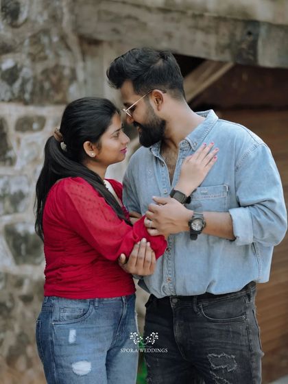 The couple looking at each other, their hands gently touching, a simple yet powerful portrait of their connection.