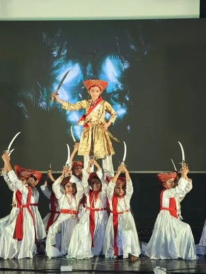 Storytelling through dance is one of our passions. This powerful formation is from a thematic performance based on the story of Tanaji, showcasing dramatic choreography and teamwork during our annual show.