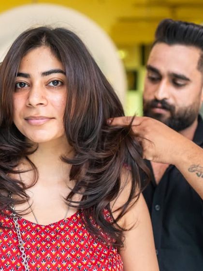 Our stylist adding the finishing touches to a beautiful layered haircut. We focus on the details to ensure your cut is perfect from every angle.