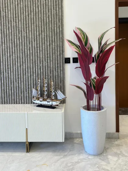Love the look of plants but worried about upkeep? Our high-quality artificial plants are the perfect solution. This beautiful artificial Cordyline plant adds a touch of sophisticated red and green to this living space, no watering needed.