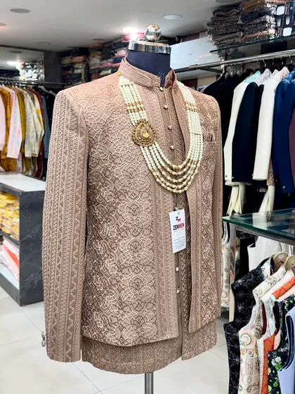 Showcasing my work in the trendy Mocha Brown, this Jodhpuri suit is perfect for summer weddings. The detailed fabric and lightweight design are paired with a traditional pearl necklace for a complete, stylish look.
