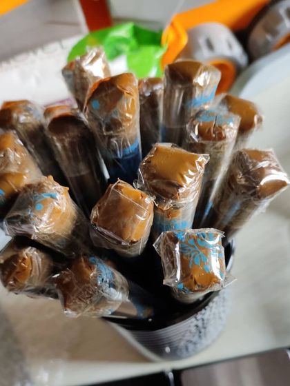 A close-up of the henna paste inside the cones. You can see the rich, dark color of the organic henna I use.