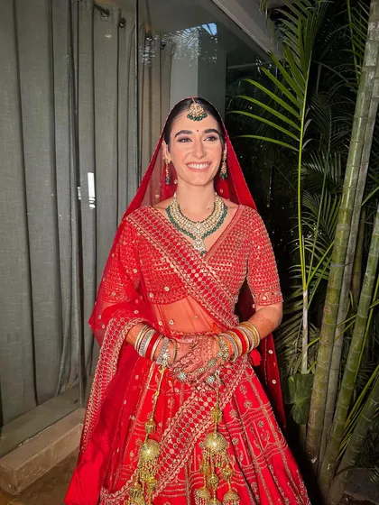 The joy of a bride on her wedding day is unmatched. Here, our beautiful Italian bride, Vittoria, is absolutely radiant in her traditional red lehenga, with makeup kept classic and elegant to honour the occasion.