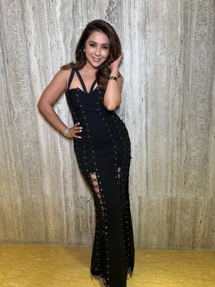 A happy, confident pose. The full length view shows how the hair and makeup work together with the outfit to create a complete, show stopping look.
