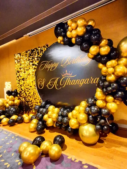 A side angle of the elegant black and gold setup, highlighting the custom calligraphy on the backdrop.