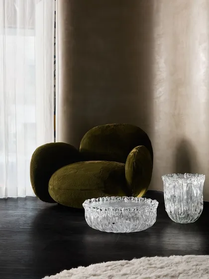 A moody and sophisticated corner of the Ventura showroom, where we paired a dark, velvet armchair with sculptural glass accessories. The play of light and shadow creates an intimate, luxurious feel.