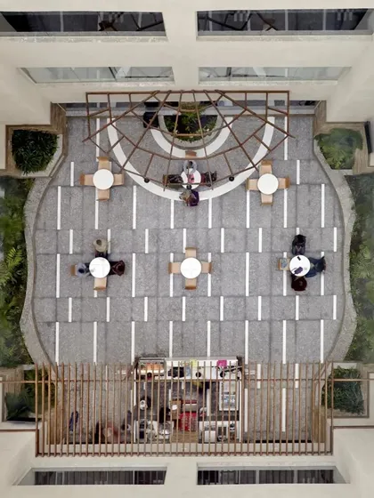 An aerial view of the atrium shows the symmetrical and organized layout. This perspective highlights how we use geometric patterns and open space to create a sense of order and tranquility from every angle.