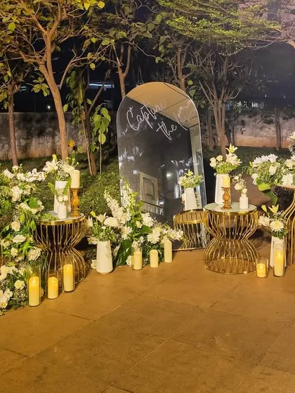 An enchanting entrance installation featuring a cascade of white flowers, candles, and elegant gold tables. This set a romantic and luxurious tone for the evening.