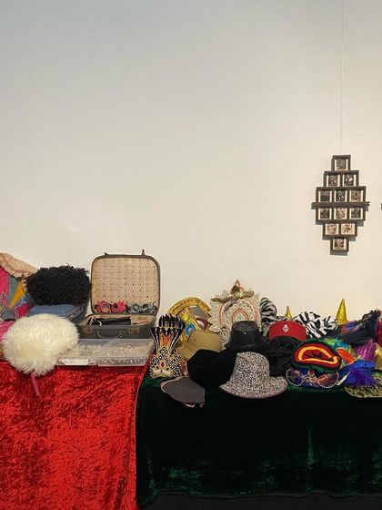 A table laden with props, hats, and accessories for the 'Pop Up Studio' at the 'Southern Stars' show. This interactive component allowed visitors to play and create their own cinematic personas.