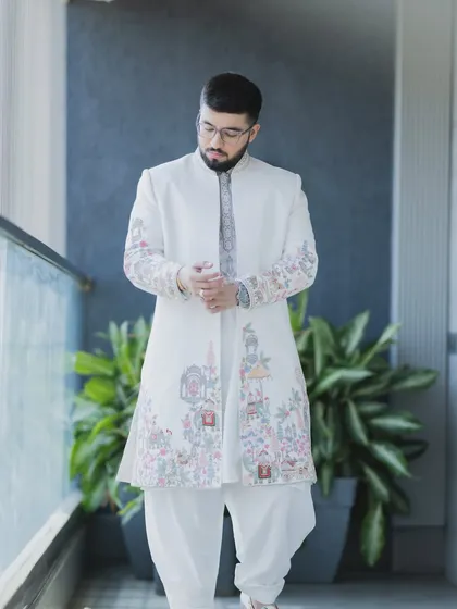 Here you can see the detailed embroidery on the groom's sherwani. My makeup and styling work is designed to complement the outfit, not overpower it, creating a balanced look.