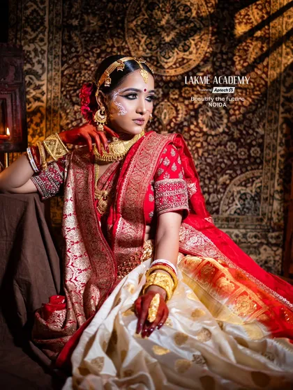 Master the art of regional bridal makeup with our specialized training. This stunning Bengali bridal look, inspired by the elegance of "Paro," showcases the intricate details, from the traditional chandan art to the classic red and gold saree styling.