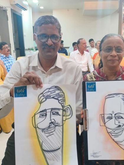 A couple holding their individual caricatures at an event at Hotel Shreyas in Pune. It's fun to see the different styles side-by-side.