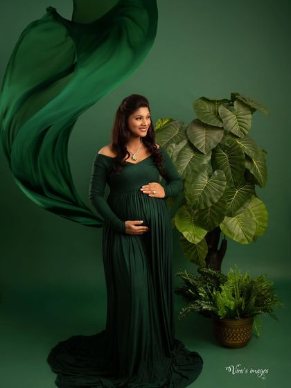 Another take on the flowing green gown, this shot captures the fabric in mid-air, adding a dynamic and powerful element to this elegant studio portrait.