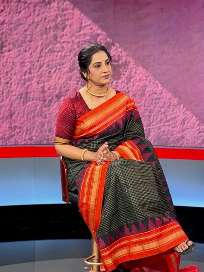 A candid shot during an interview, showing the makeup under studio lights.
