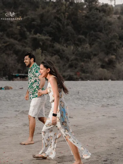 Another candid shot capturing the couple's laughter and joy as they walk along the river, a perfect memory from their destination pre-wedding shoot.