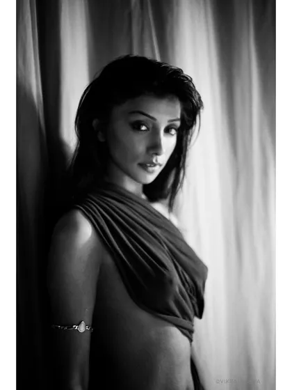 Soft gaze, bold spirit. A classic black and white portrait of Deepal Shaw, using drapery and shadow to create a mysterious and alluring mood.