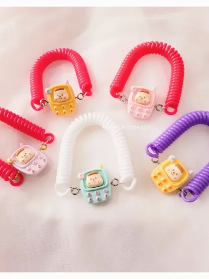 How cute are these spiral adjustable Rakhis? The telephone charm adds a fun, quirky touch, and the stretchy band makes it easy for kids to wear. It's a Rakhi and a toy in one.