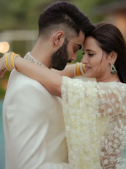A candid moment of dance and movement during an engagement shoot in Mumbai. The natural light and the couple's interaction create a dynamic and romantic image that feels alive.