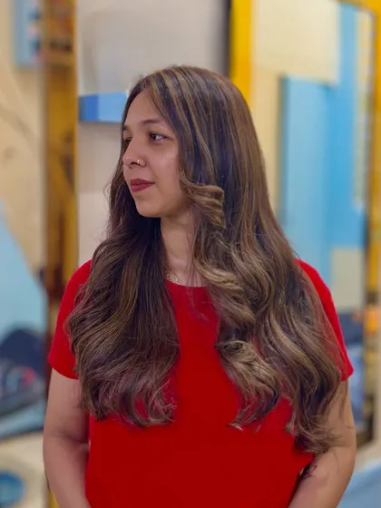 A side profile showcasing the beautiful dimension of the Toffee hair color, with highlights framing her face.