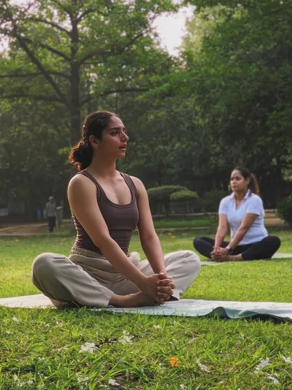 A moment of shared presence in our outdoor yoga class. Here we are seated in Baddha Konasana, a hip-opening pose that encourages a mindful connection to the body.