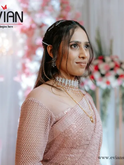 Ready for the reception party. This is a soft glam look with a sparkling saree, perfect for an evening of celebration. We also styled her hair with simple accessories to complete the look.