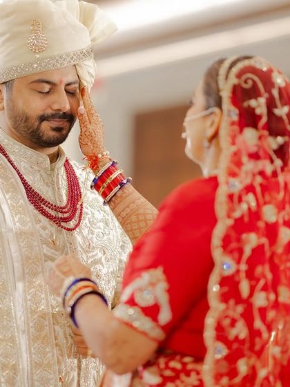 A mother's blessing for her son just before the ceremony begins. We cherish these quiet, emotional family moments that happen amidst the grand celebration.