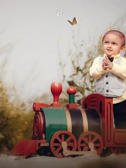 A moment of awe as butterflies flutter by. This little boy is completely captivated during his train-themed outdoor session.