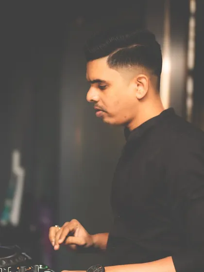 A profile shot of me concentrating on the decks, ensuring every mix is perfect.
