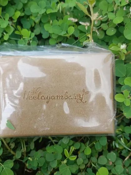 A close-up of the Multani Mitti soap bar, showing the Neelayambary logo embossed on it. This natural clay soap is a traditional remedy for oily and acne-prone skin.