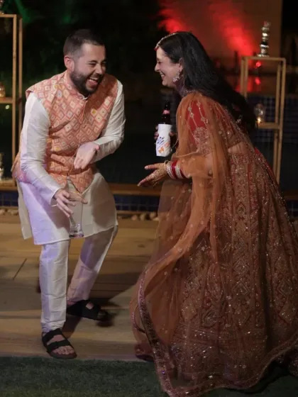 A candid shot of a guest and the bride sharing a playful dance moment. It's these unscripted interactions that add so much life to a wedding story.