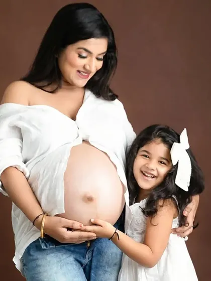 A joyful maternity photo celebrating the bond between a mother and her daughter. Capturing the excitement of a big sister-to-be is a key part of my family maternity sessions.