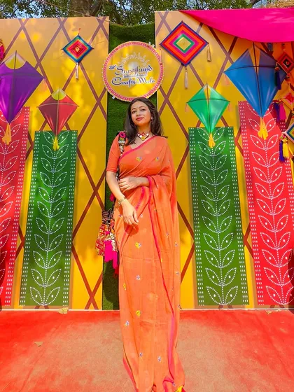 A day out in a beautiful orange mul cotton saree for Poila Boishak. The vibrant color and comfortable fabric make it perfect for celebrating the Bengali New Year at a mela.