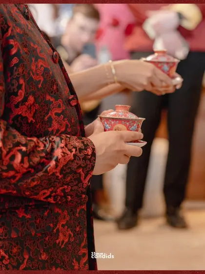 Holding history in porcelain cups. This close-up shot focuses on the details of the Chinese tea ceremony, a ritual steeped in respect and family connection.