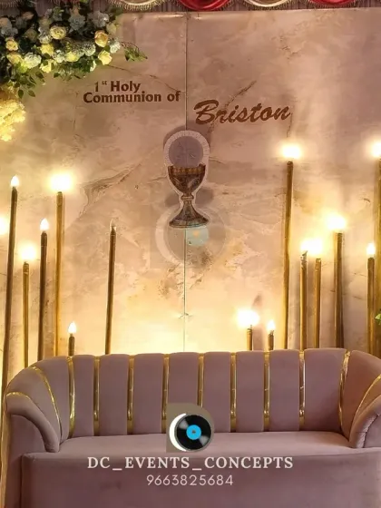 An elegant and serene stage for a First Holy Communion, using a soft color palette, a central chalice motif, and tall, candle-like floor lamps for a reverent atmosphere.