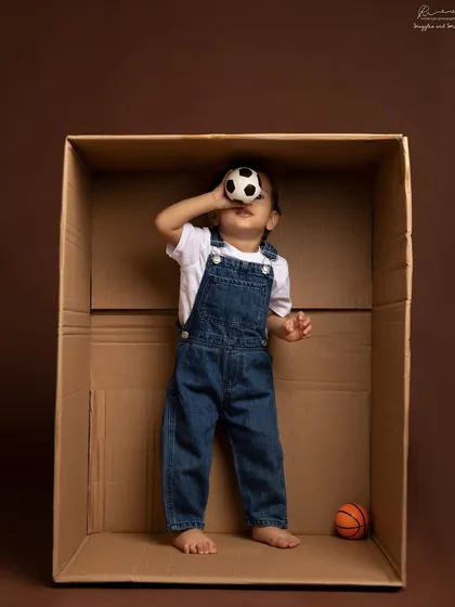 Thinking outside the box, by playing inside one. Sometimes the simplest props spark the most imagination and lead to the most playful photos.