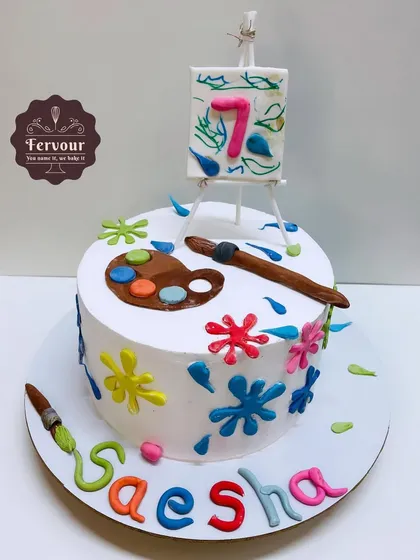 A painting and drawing theme cake for a 7th birthday. This chocolate mousse cake is decorated with a mini easel, a paint palette, and colourful splashes, celebrating a young artist's creativity.