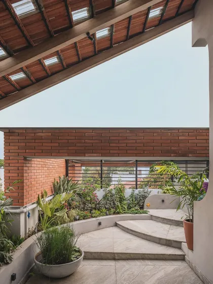 This rooftop was transformed into a lush terrace garden. By using built-in planters and a mix of native plants against an exposed brick wall, we created a secluded green retreat with open sky views.