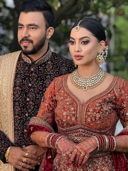 A regal portrait of the bride and groom. Their coordinated outfits and my styling create a stunning and cohesive look for their reception.