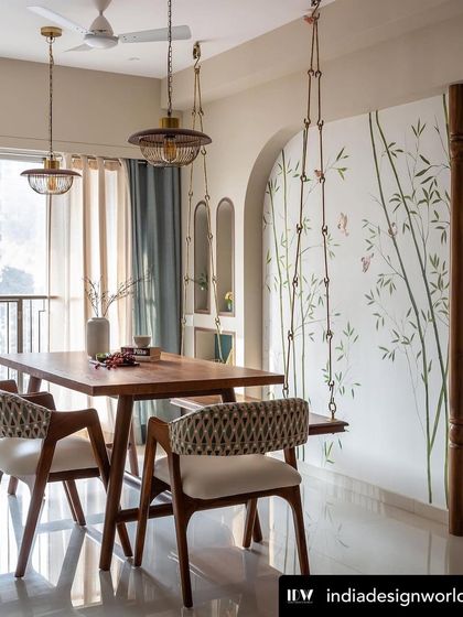 A hand-painted mural of bamboo and sparrows creates a light, airy backdrop for this dining area. The artwork complements the wooden swing, bringing a touch of nature indoors.