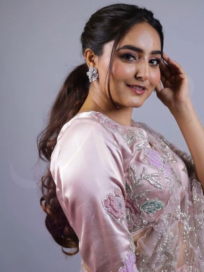 A lovely portrait shot highlighting the floral appliqué and cutdana work on the sleeve and blouse of our baby pink Indo-Western saree.