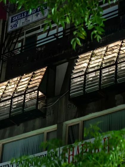 The plug-in facade system designed for a workspace in Green Park, New Delhi. This exterior view shows the adjustable aluminum louvers, which function as light shelves and screens to regulate sunlight, reducing glare and heat gain for the offices inside.